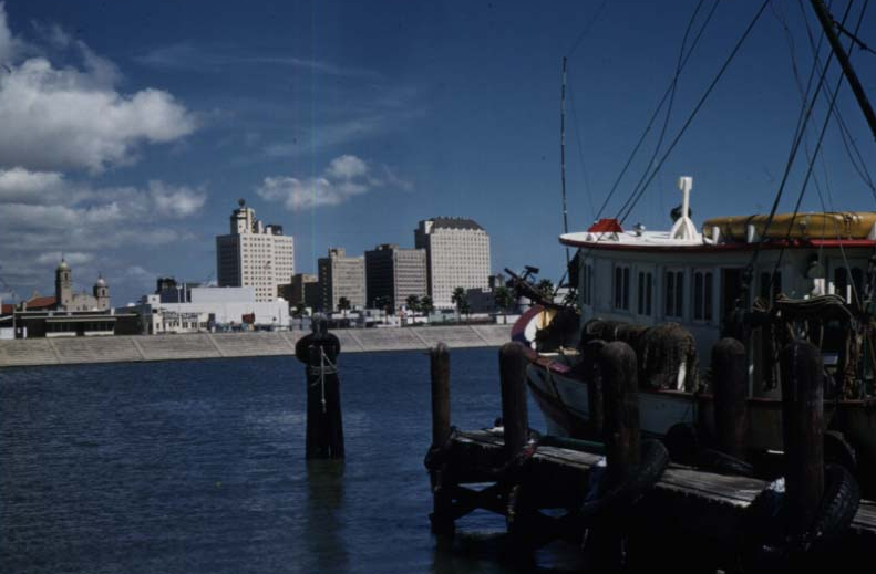 The Robert Driscoll 10 1950s boat docked next to a small pier