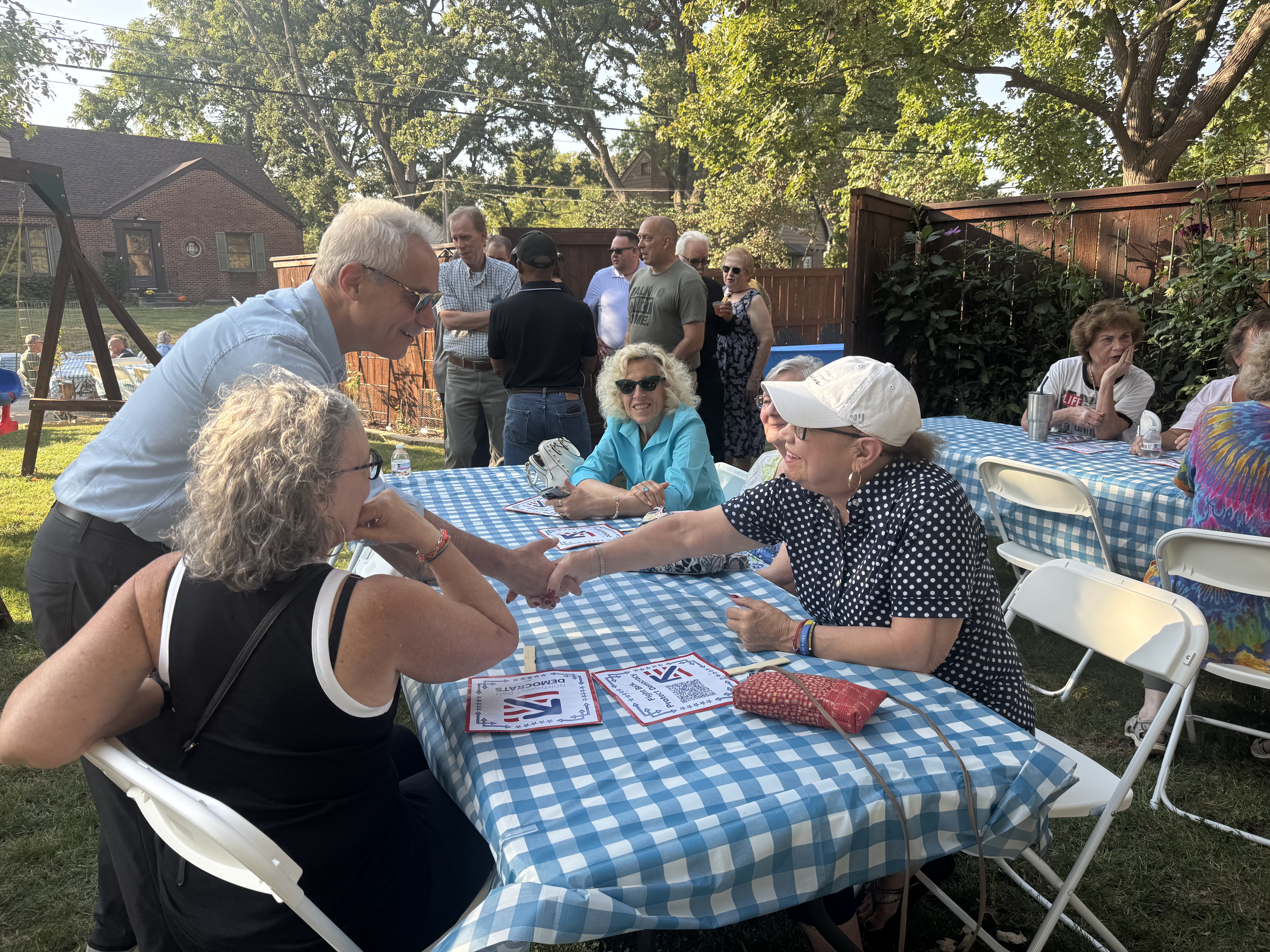 Rahm Emanuel talks to fish fry guests in the front yard of state Rep. Sean Bagniewski's home on Saturday, Sept. 27, 2025.