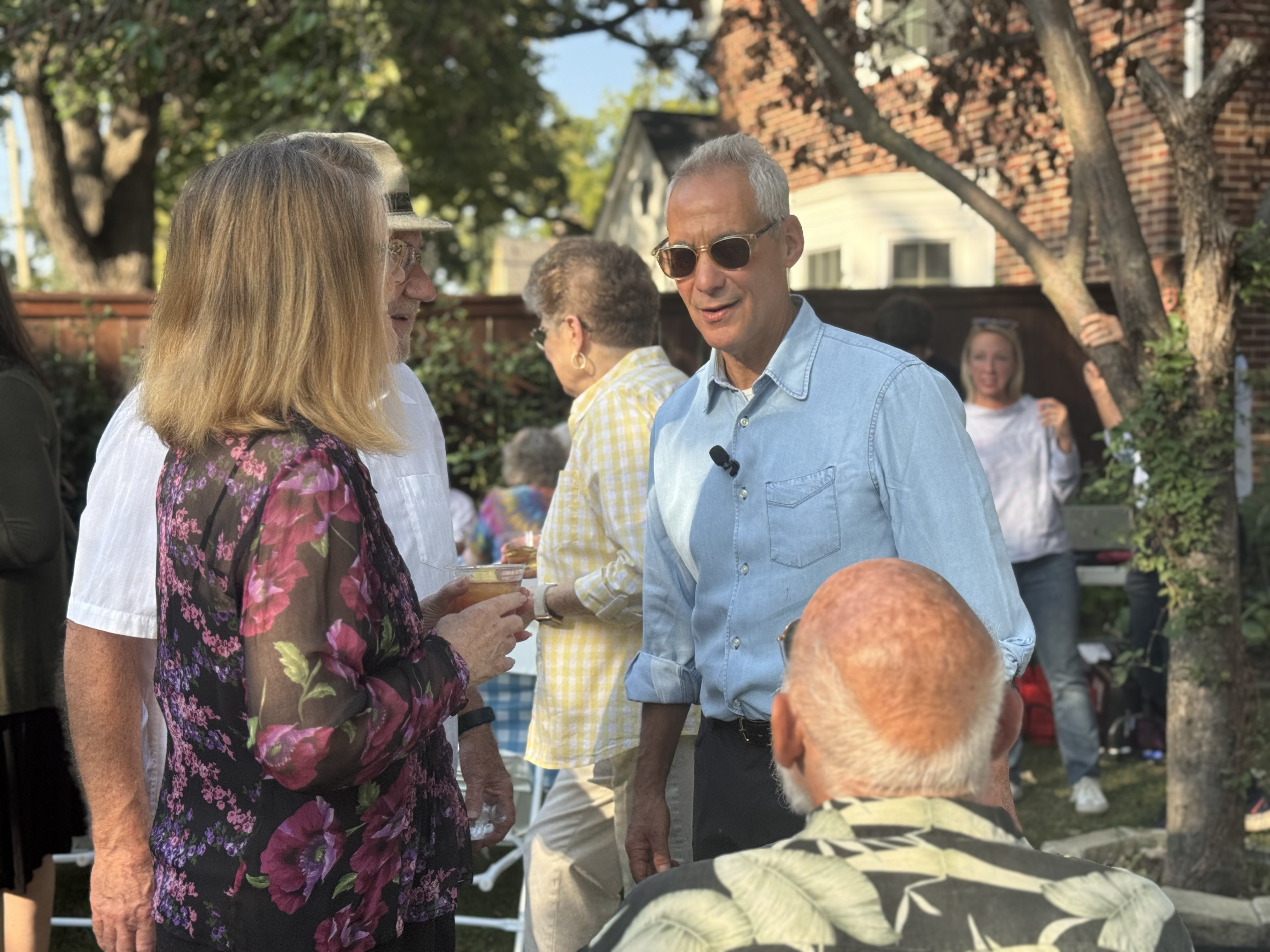 Rahm Emanuel talks with attendees at a Des Moines fish fry on Saturday, Sept. 27, 2025.